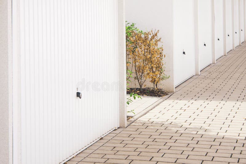 A row of garage doors with a little nature in between. A row of garage doors with a little nature in between